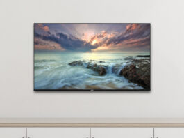 Fernseher an der Wand über einer Kommode