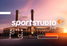 Schriftzug "ZDF Sportstudio live" vor Stadion mit Olympischen Ringen.