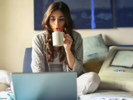 Frau im Bett mit Laptop
