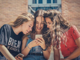 Drei junge Frauen mit einem Vodafone Smartphone