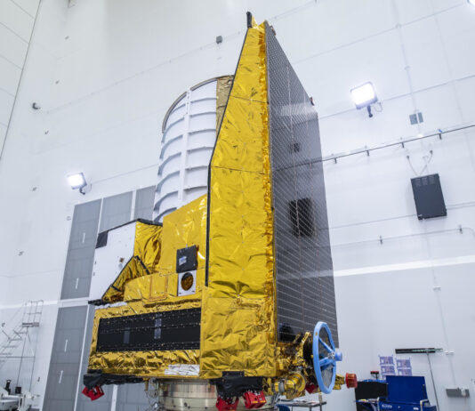 Das Weltraumteleskop Euclid steht in einer Fertigungshalle auf einem Adapter zur Befestigung auf einer "Falcon 9"-Rakete.